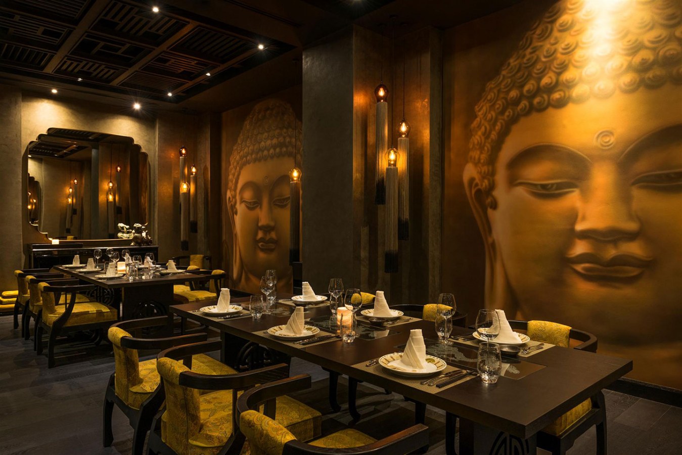 The perfectly set tables at Buddha Bar Dubai with Buddha motifs on the walls everywhere